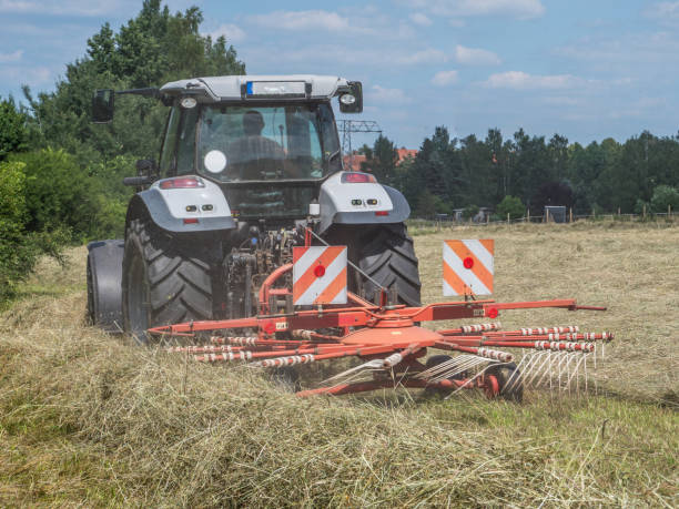 istock Tractor turning hay in a field 1093992584