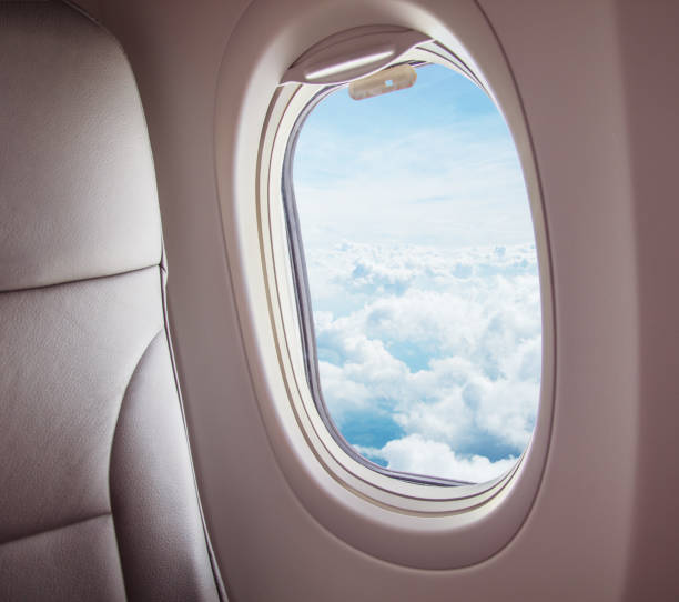istock Airplane interior with window view of clouds. 1093992774