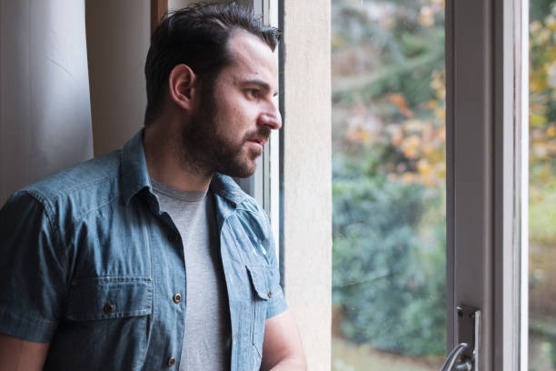 istock Man suffering and feeling alone at home 1093992780