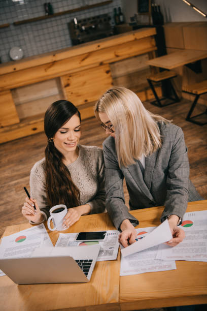 istock attractive colleagues talking in cafe while working near laptop 1093993780
