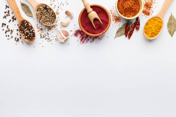 Various indian spices in bowls and spoons on background Various indian spices in bowls and spoons on white background, top view, copy space sumac spice stock pictures, royalty-free photos & images