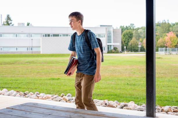 istock Happy teenager studying outdoors at a picnic table. 1093996788