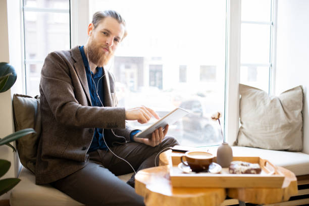 istock Satisfied hipster man working in cafe 1093997682