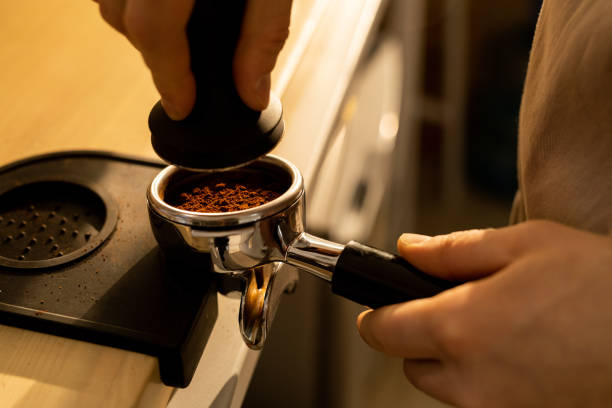 istock Pressing ground coffee into portafilter 1093997752
