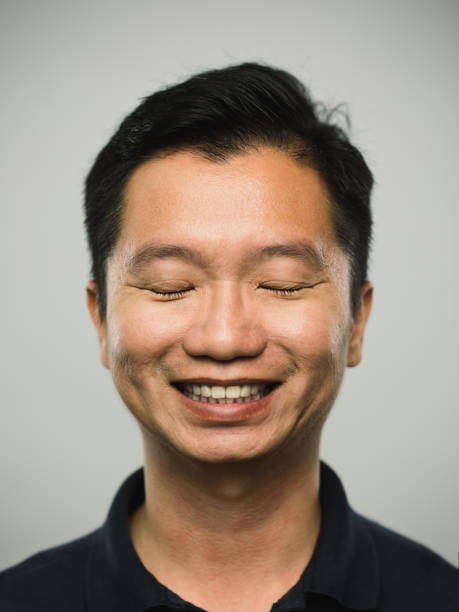 istock Real chinese man with happy expression with eyes closed 1094001404