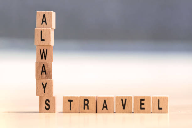 wood cubes with the words always travel