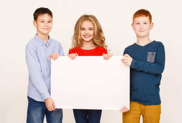istock Children showing blank placard board for text 1094001704