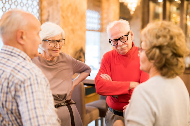 Group of seniors standing in circle and chatting