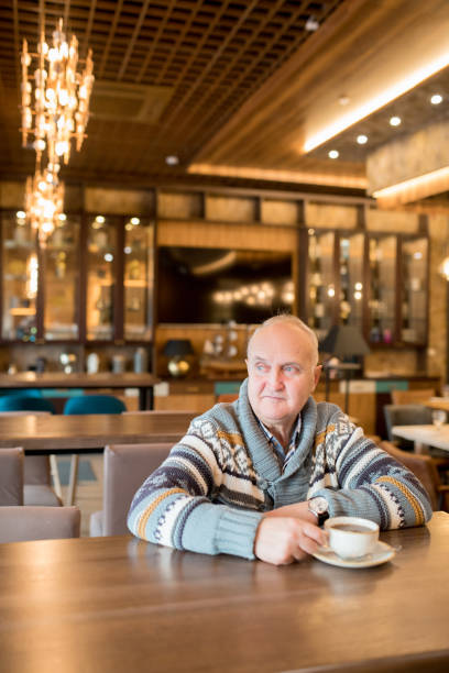 istock Content mature man drinking coffee in cafe 1094005550