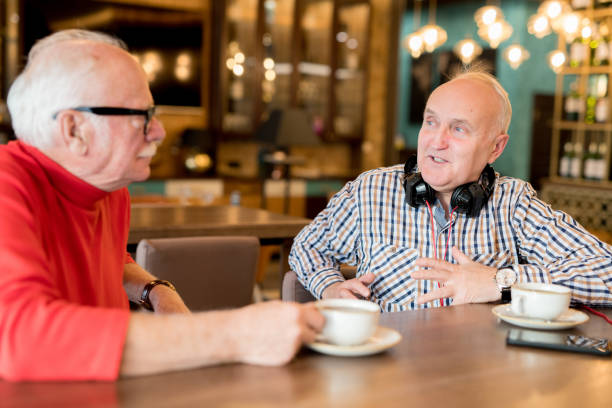 istock Modern mature friends chatting in cafe 1094005552