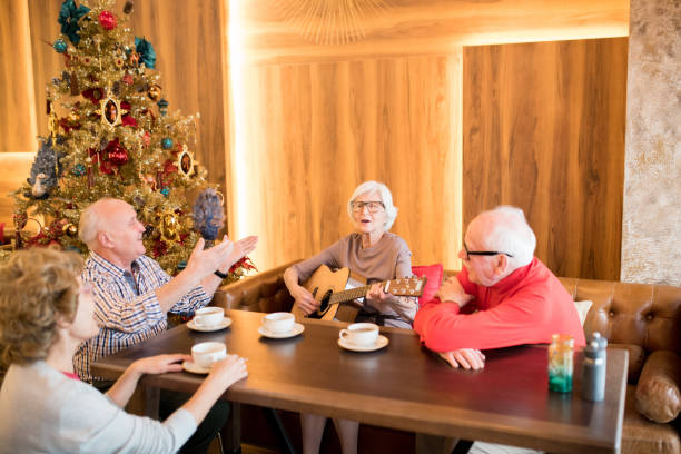 istock Elderly lady playing guitar at Christmas party 1094005650