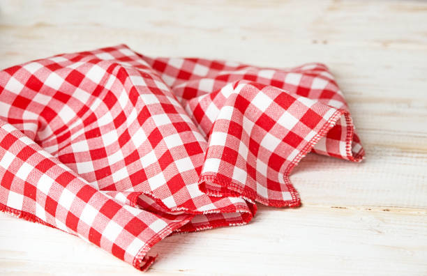 istock Red checkered tablecloth on a wooden table 1094006254