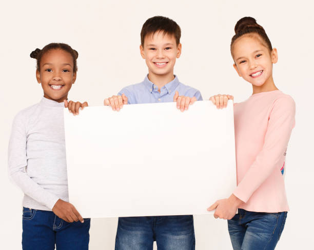 istock Kids showing blank placard board for text 1094006972