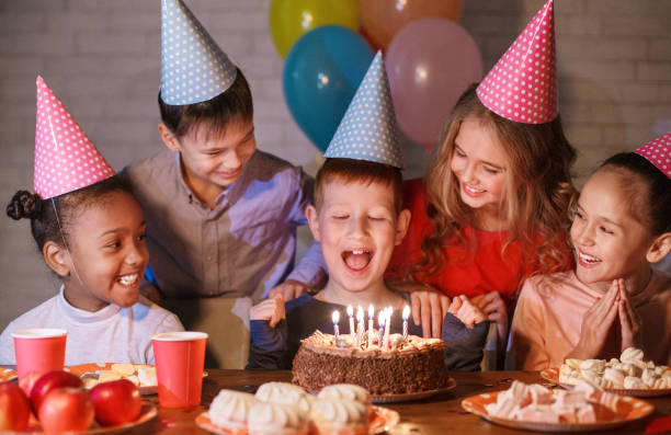 istock Happy boy in party hat with birthday cake 1094006996