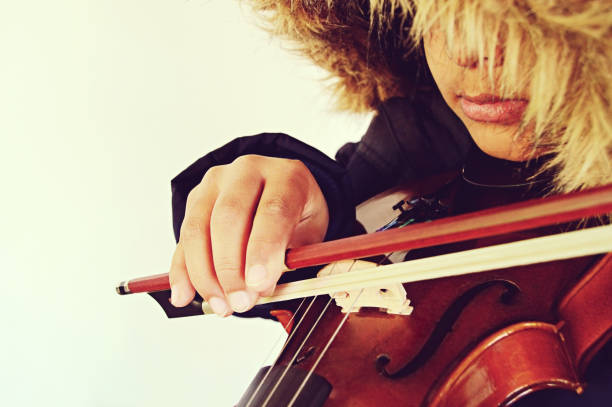 istock A boy playing the stringed and bowed musical instrument, the violin 1094007954