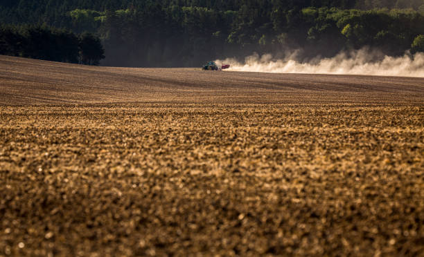 istock Tractor plowing a dry farm field 1094009862