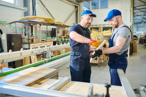 istock Engineers examining wooden plank at factory 1094010162