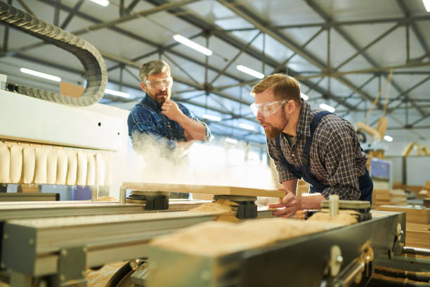 istock Worker blowing off dust from wooden detail 1094011052