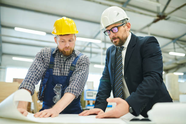 istock Businessman examining sketch with engineer 1094011078