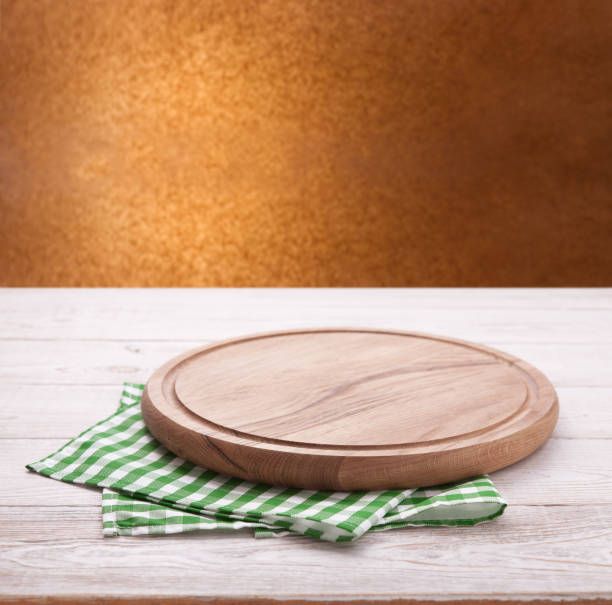 istock Kitchen towel and pizza board on wooden table. Napkin close up top view mock up. Kitchen rustic background. 1094011168