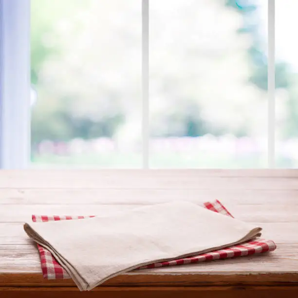 Photo of Napkin on the table and kitchen window blurred background
