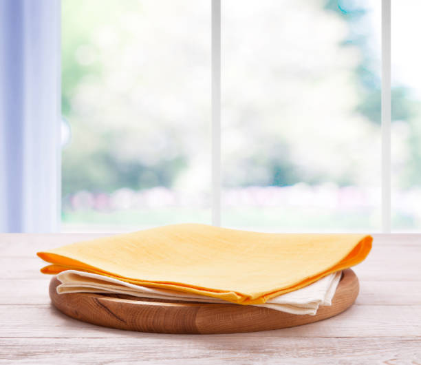 istock Kitchen towel on wooden table. Napkin close up top view mock up for design. Kitchen rustic background. 1094011180