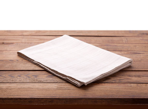 istock Wooden deck table with white napkin isolated on white. Kitchen background, product montage display. Mock up. 1094015072