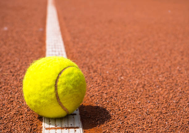 istock Tennis ball on one line