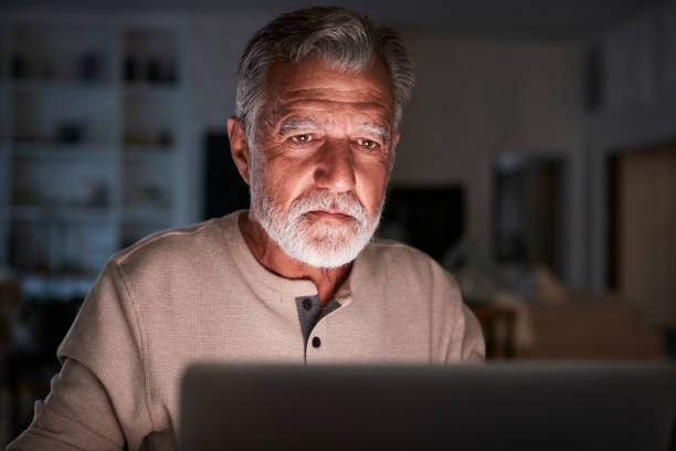 istock Senior Hispanic man checking his finances online at home using a laptop computer at night, close up 1094018118