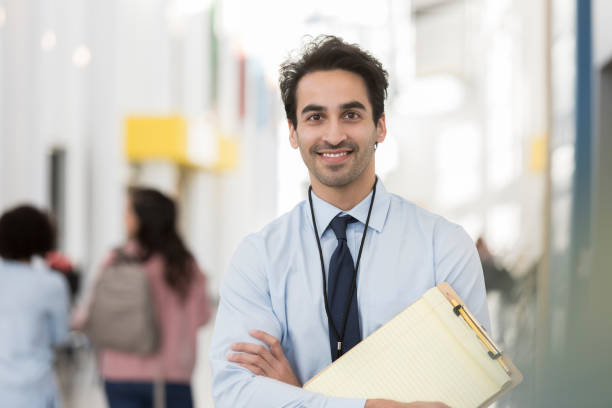 istock Male high school teacher smiles for camera on first day 1094021024