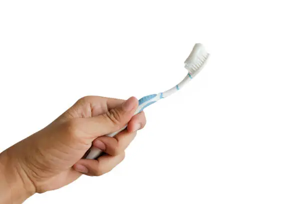 Man hand holding toothbrush on white background