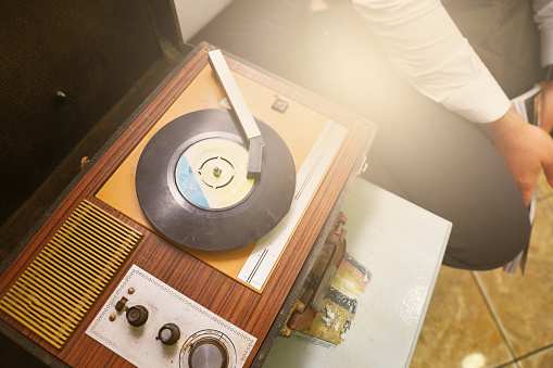 Dirty and dusty vintage record player with a vinyl record