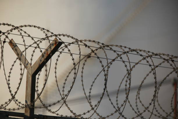 istock Low Angle View Of Barbed Wire Against Sky 1094025796