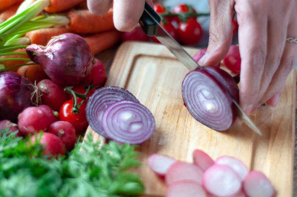 istock Woman Cutting Radish on Cutting Board 1094027668