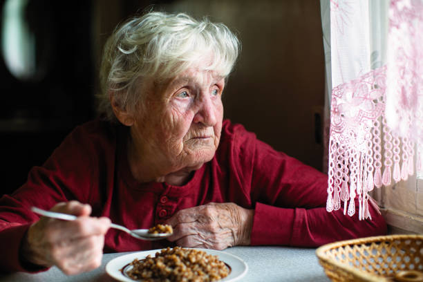 istock Elderly woman eats sitting at the table. 1094027714
