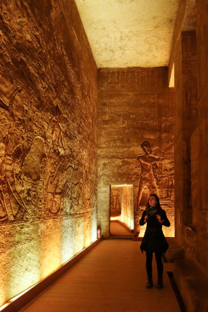 istock Abu Simbel - Traveller inside Temple Ramesse II looking on hieroglyphs 1094028248