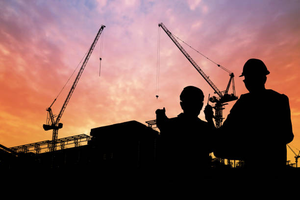 istock silhouette of engineers with worker in construction building 1094030228