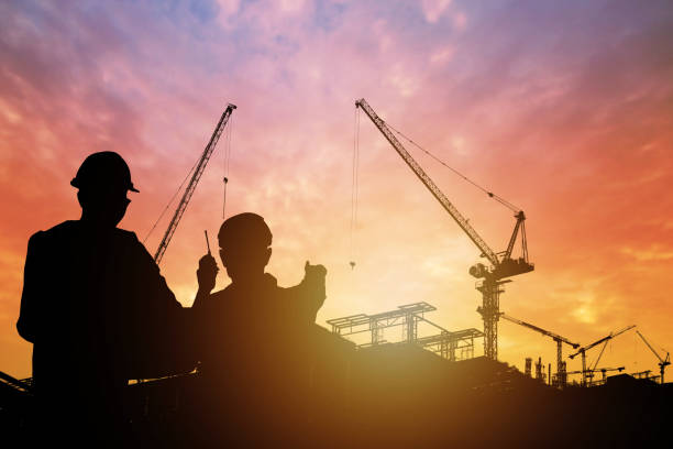 istock silhouette of engineers with worker in construction building 1094030300