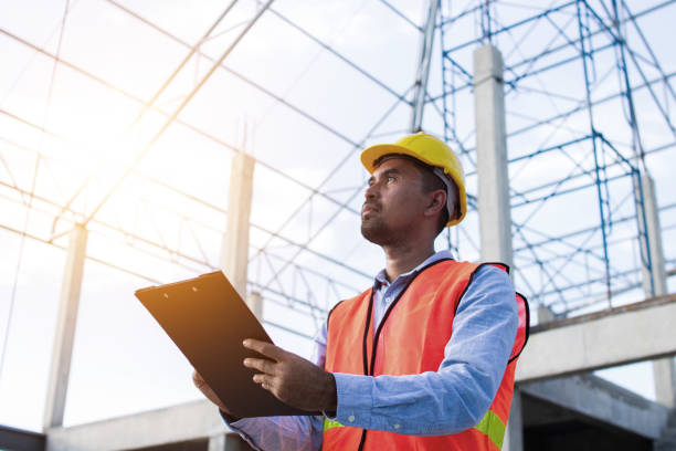 Engineer or inspector checking progressing work in construction site stock photo