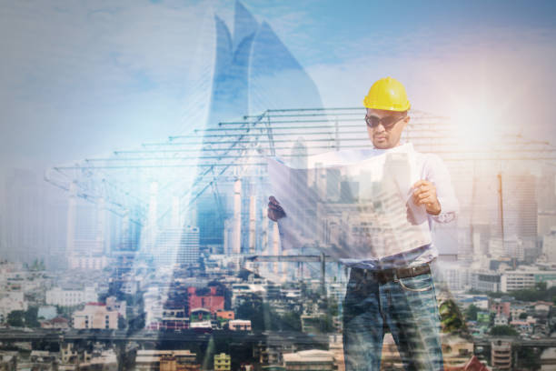 istock Construction concept, exposure of engineer talking looking on blueprint  with tower and building background 1094032402