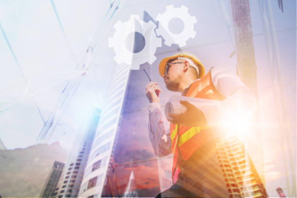 istock Construction concept, exposure of  engineer talking on radio with tower building background 1094032406