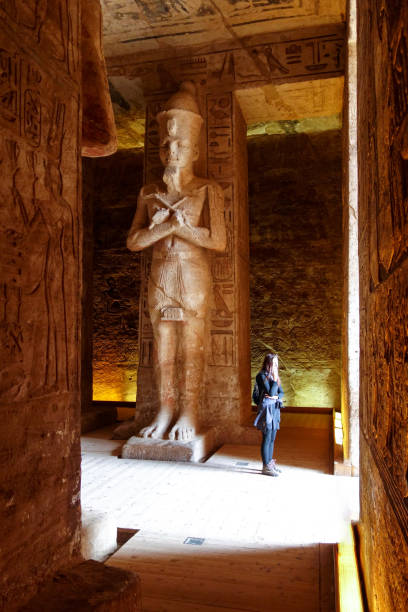 istock Abu Simbel - Traveller inside Temple in Egypt front of gigantic statues 1094033880