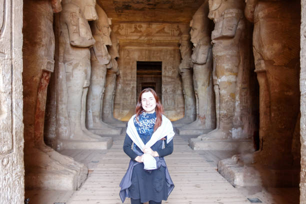 istock Abu Simbel - Traveller inside Temple of Rameses II looking at camera and smiling 1094034510
