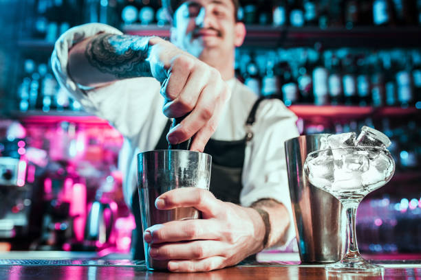 istock Expert barman is making cocktail at night club. 1094035828