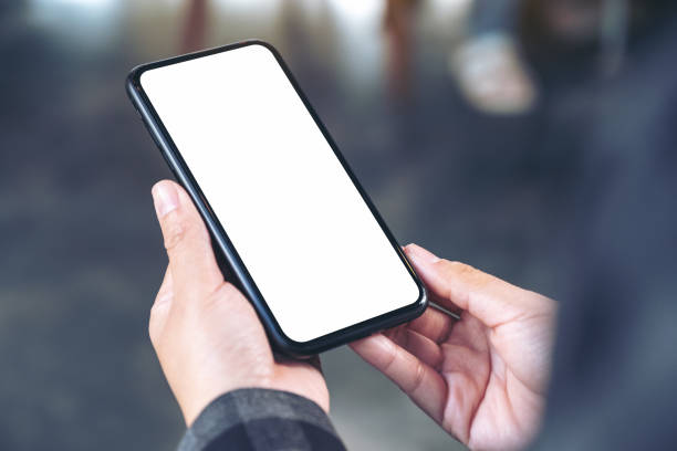 istock Mockup image of hands holding black mobile phone with blank white screen 1094036328