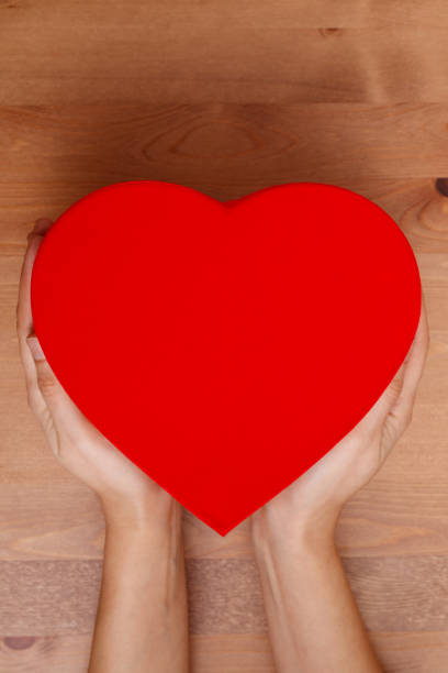 istock Woman hands holding red heart box 1094041324
