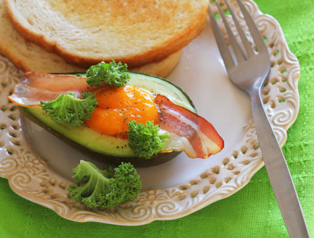 istock Breakfast. Avocado Egg Boats with crunchy bacon, kale cabbage 1094044618
