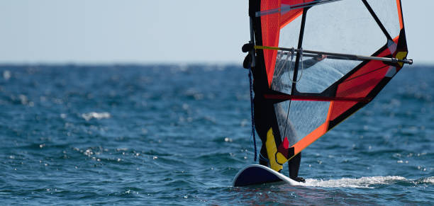 istock Windsurfer surfing the wind on waves in ocean 1094045724