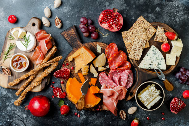 istock Appetizers table with italian antipasti snacks. Brushetta or authentic traditional spanish tapas set, cheese variety board over black stone background. Top view, flat lay 1094050410