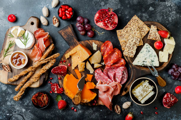 istock Appetizers table with italian antipasti snacks. Brushetta or authentic traditional spanish tapas set, cheese variety board over black stone background. Top view, flat lay 1094050534